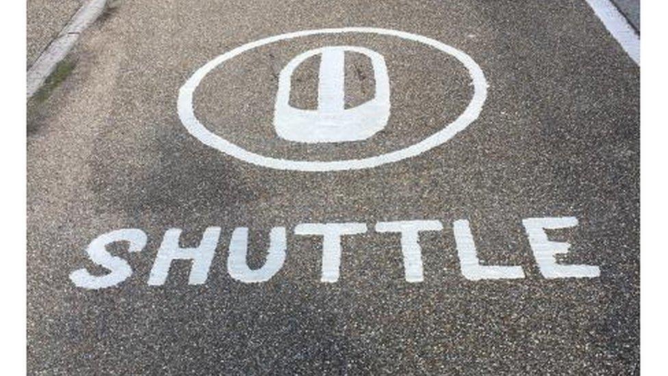 Shuttle marking on riverside path