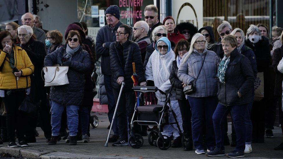 Members of the public line the street near to Iveagh Hall, in Leigh-on-Sea, the constituency office of murdered MP Sir David Amess, as they wait to pay their respects