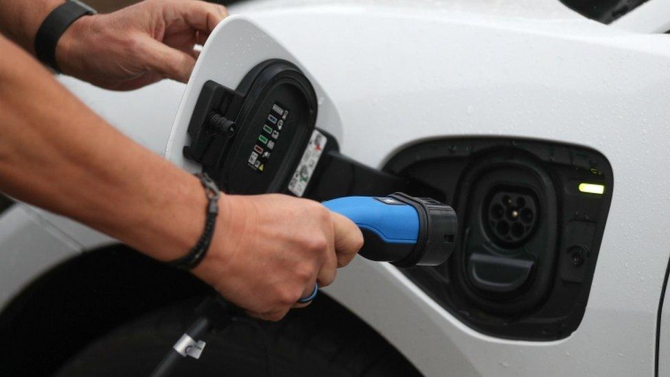 Person charging an electric car