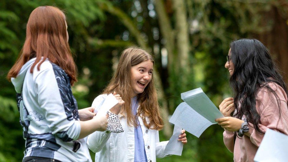 Sophie Thomas (centre) celebrates after opening her GCSE results at Ffynone House School on August 12, 2021 in Swansea