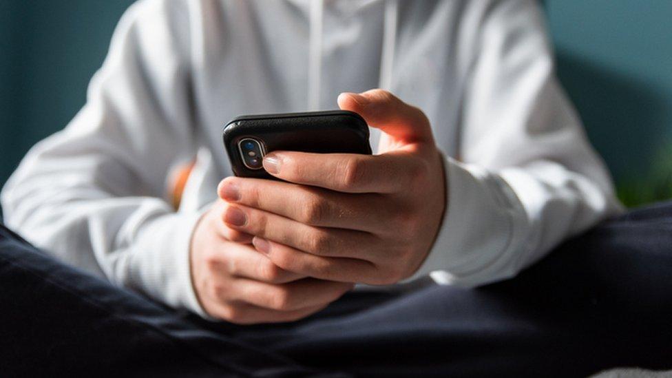 boy holding phone