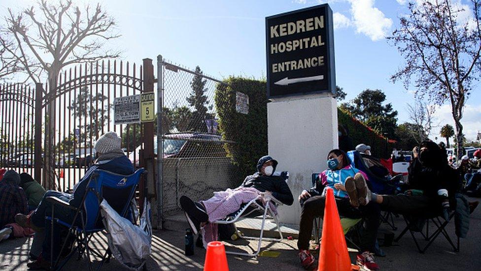 People without appointments wait in line for the potential chance to receive a Covid-19 vaccination in Los Angeles