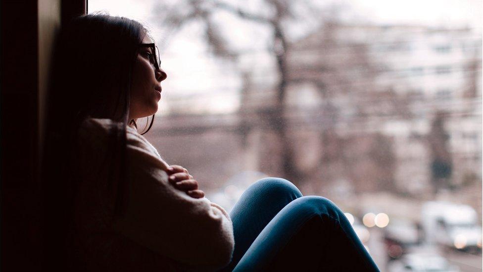 Girl looking out window