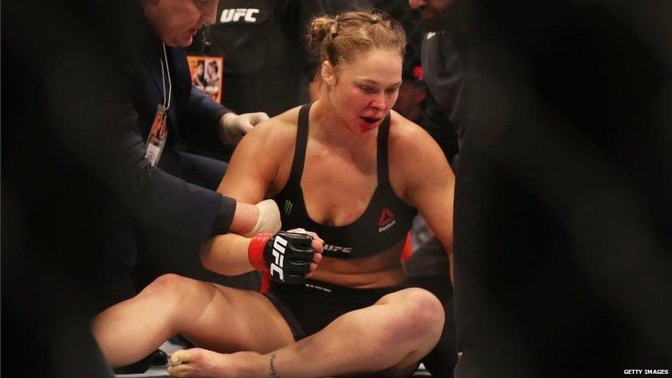 Ronda Rousey slumped on the ground