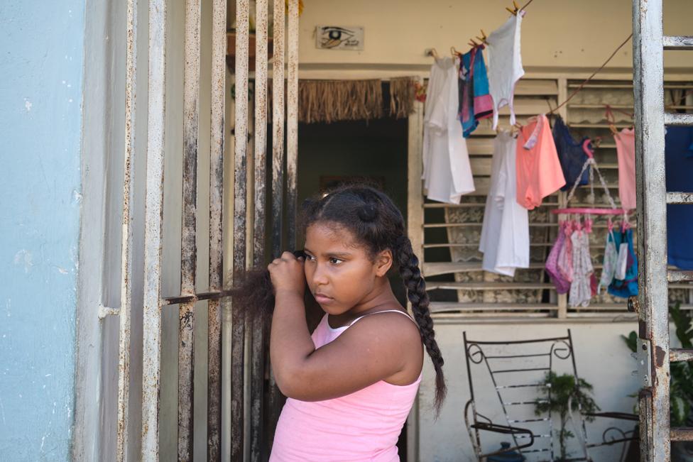 Cataleya Larrinaga Guerra (9) stands in the doorway of her grandparents home