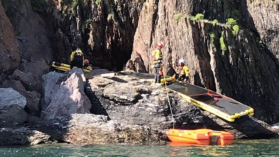 rescue operation taking place on rocks