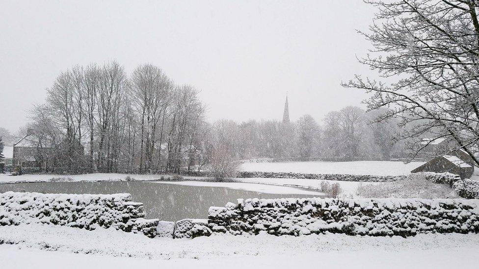 Snowy field, house and church steeple