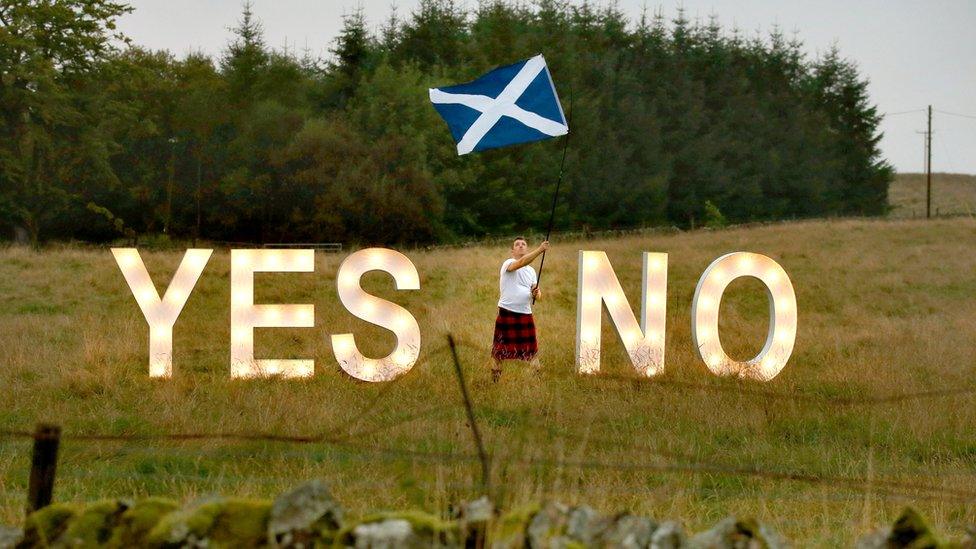 Man waves Scottish flag