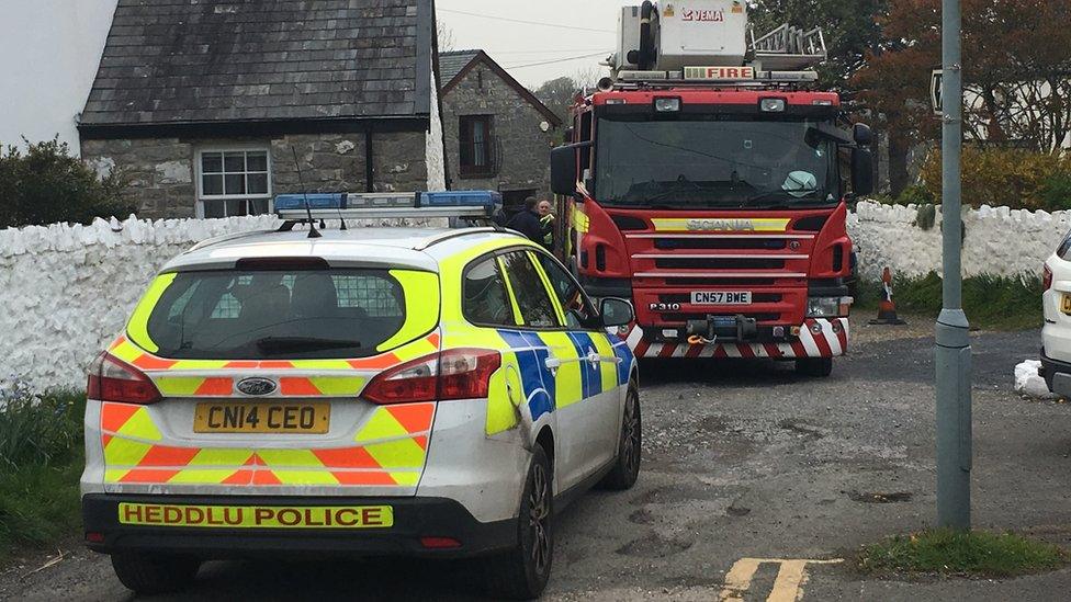 A police car and a fire engine at the scene