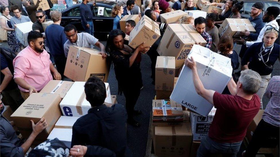 Volunteers prepare supplies for people affected by the Grenfell Tower block w