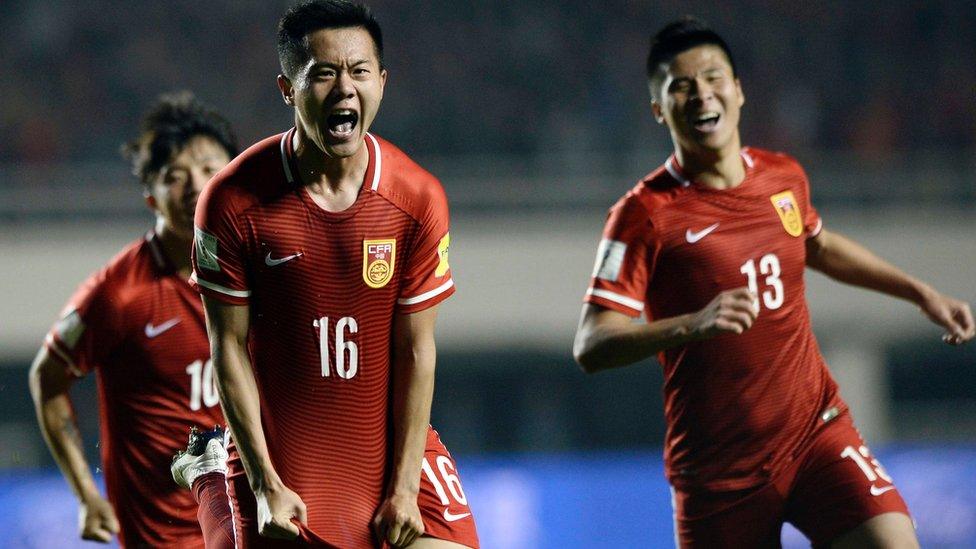 Huang Bowen (C) of China celebrates with his teammates after scoring against Qatar on March 29, 2016