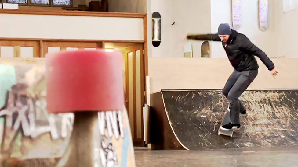 Skate rides a ramp in church skatepark