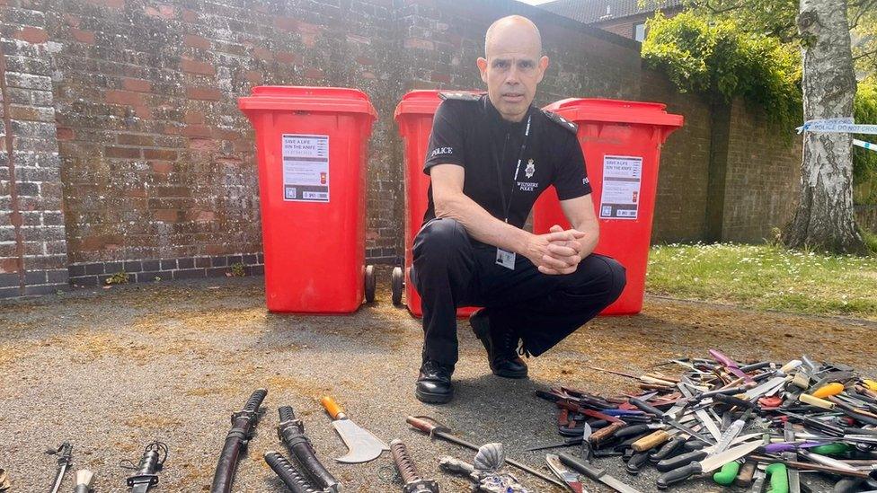 Insp David Tippetts and display of all the knifes collected by police over two weeks