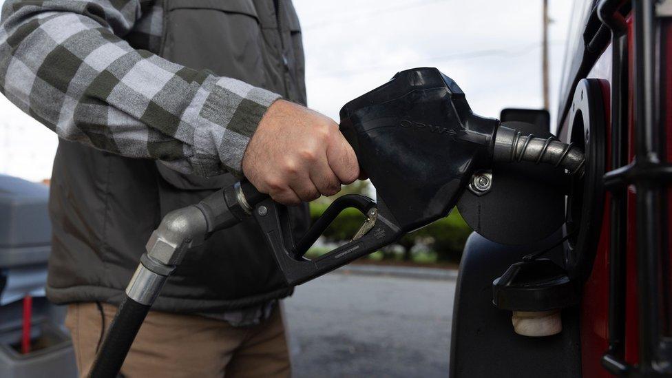 man filling his car