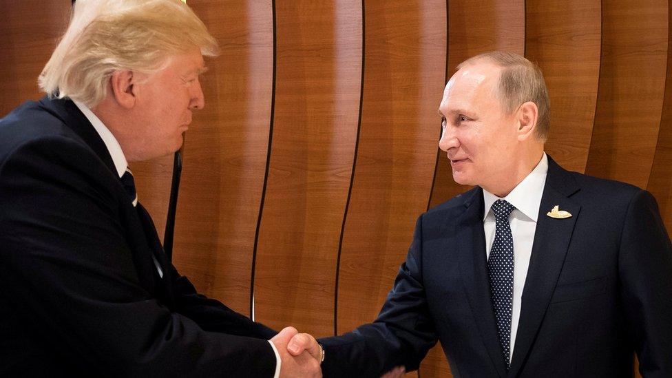 U.S. President Donald Trump and Russia"s President Vladimir Putin shake hands during the G20 Summit in Hamburg, Germany