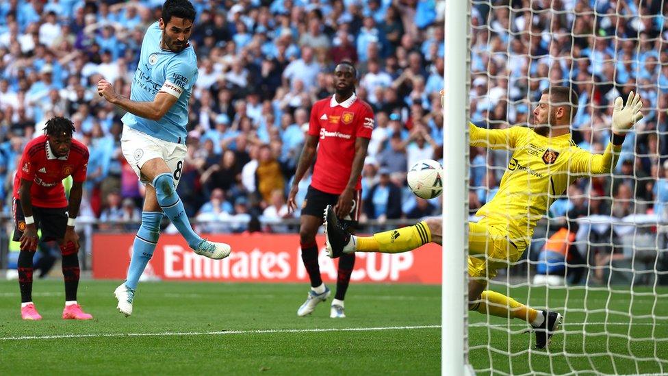 Illkay Gundogan kicking ball into the net