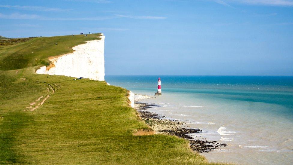 Iconic lighthouse and white chalk cliffs at Beachy Head