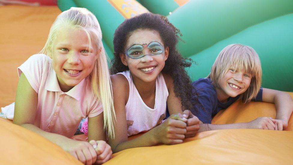 Kids on a bouncy castle.