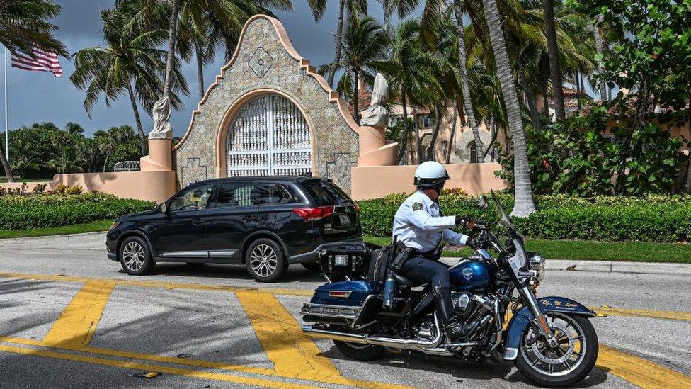 Police stand guard outside Mar-a-Lago on 9 August