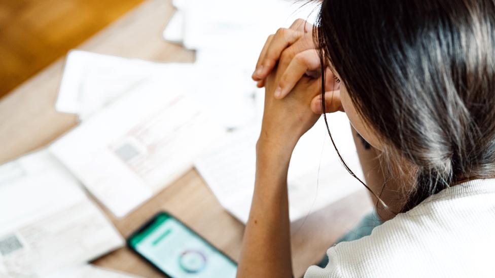 A woman looking at financial paperwork