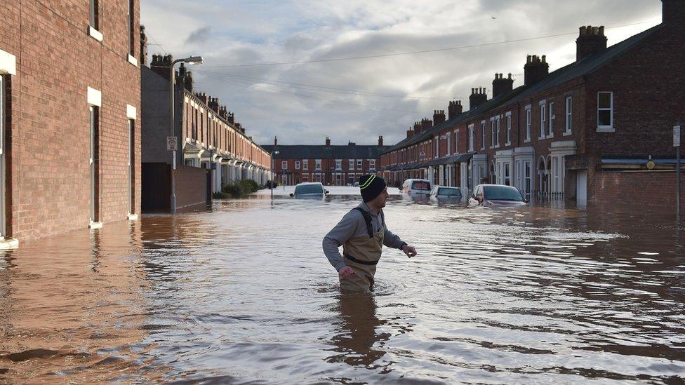 Hundreds of homes have been flooded and more than 1,000 people evacuated in Cumbria and the Scottish Borders