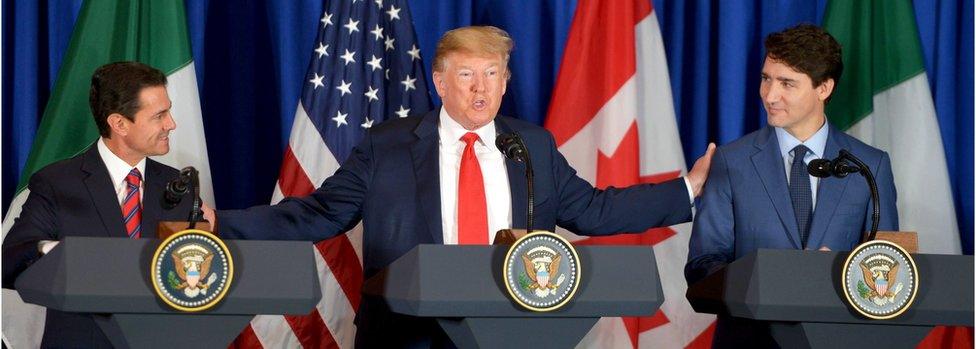 A handout photo made available by Mexico's Presidency shows Mexican President Enrique Pena Nieto (L), US President Donald J. Trump (C) and Prime Minister of Canada Justin Trudeau (R) as they participate in the signing of a trade agreement, in Buenos Aires, Argentina