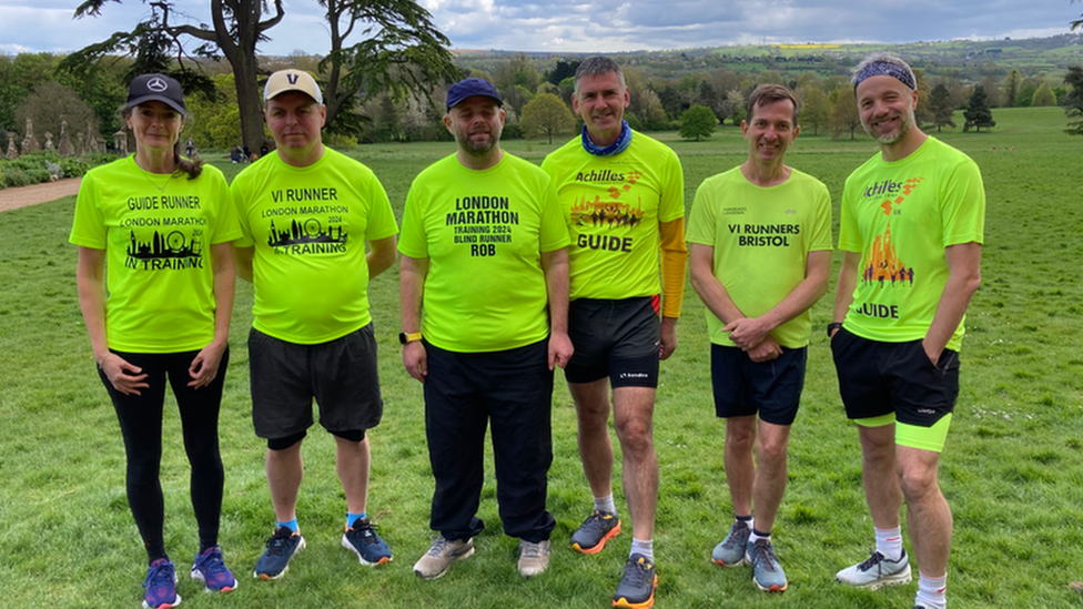 Six people in VI Runners London Marathon T-shirts