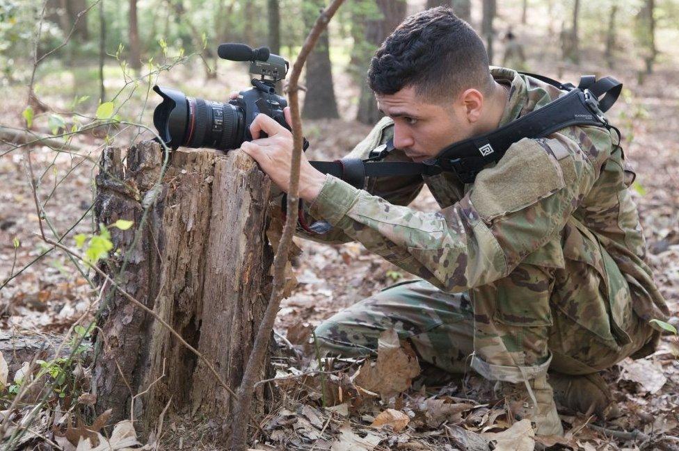 A soldier competes in the 5th annual Hilda Clayton Best Combat Camera Competition in April 2017