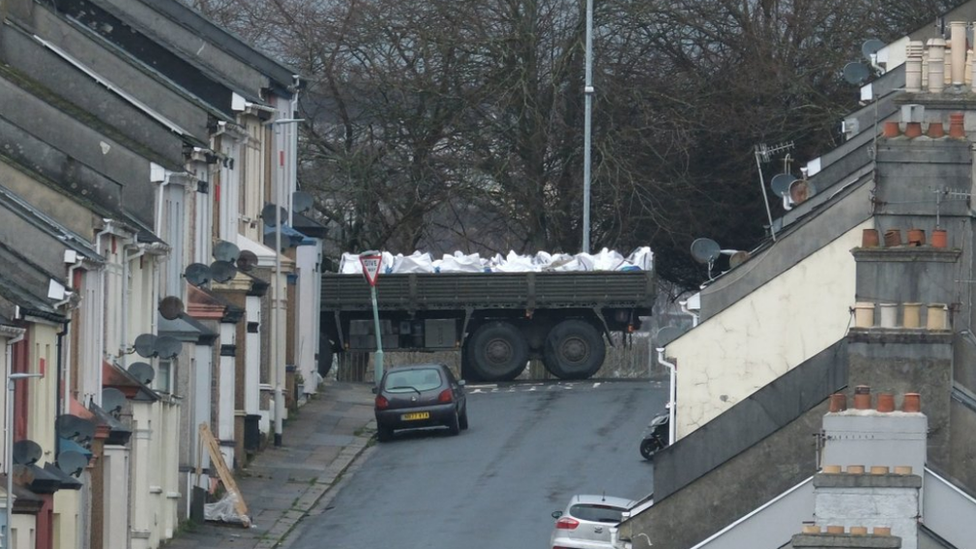 Bomb disposal experts transport the device