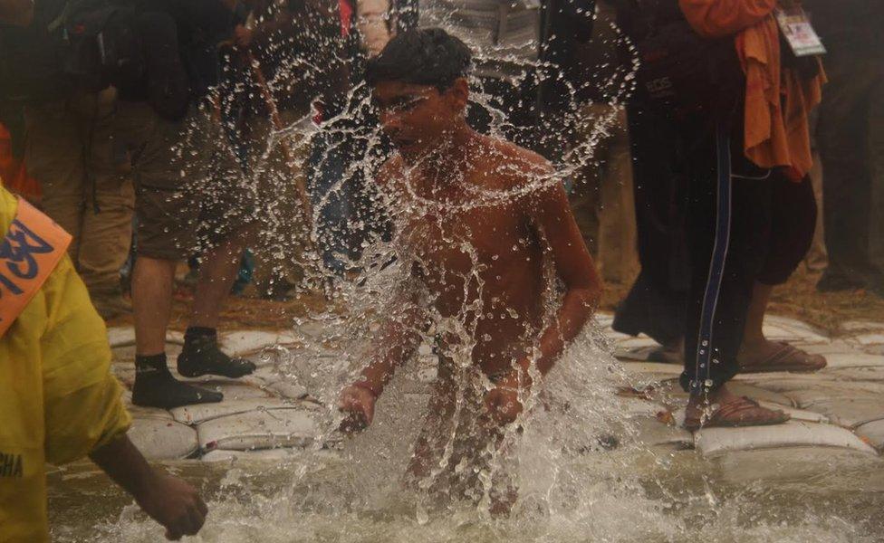 A man taking a dip in the Ganges