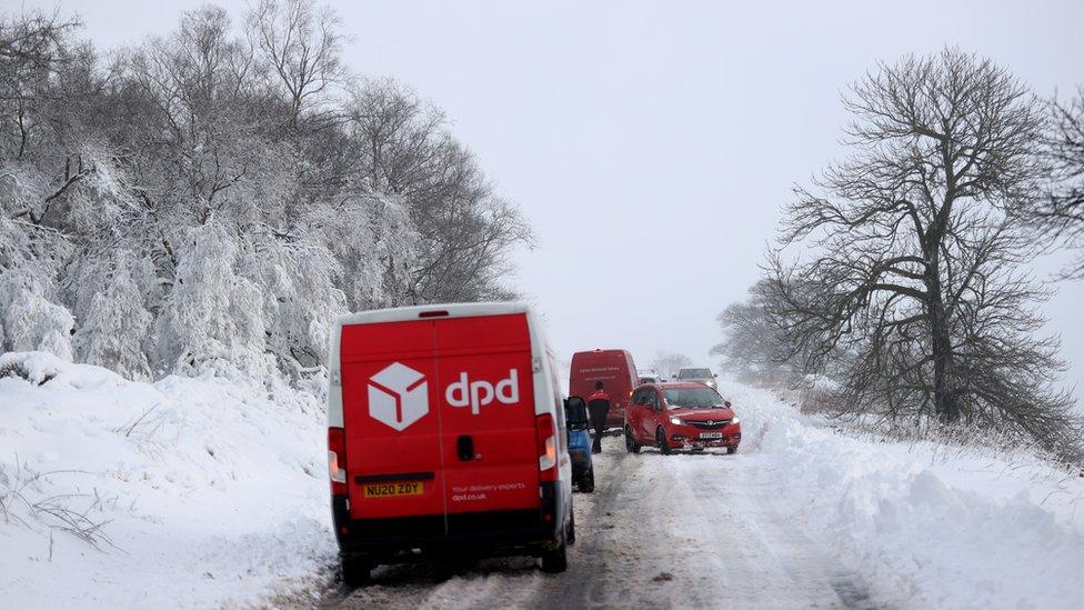 Cars stuck in snow that fell overnight from Storm Arwen, in Leek, Staffordshire