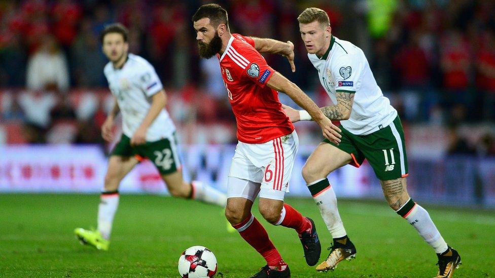 Joe Ledley of Wales holds off James McClean of the Republic of Ireland