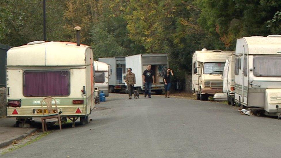 Caravans and vans parked on road