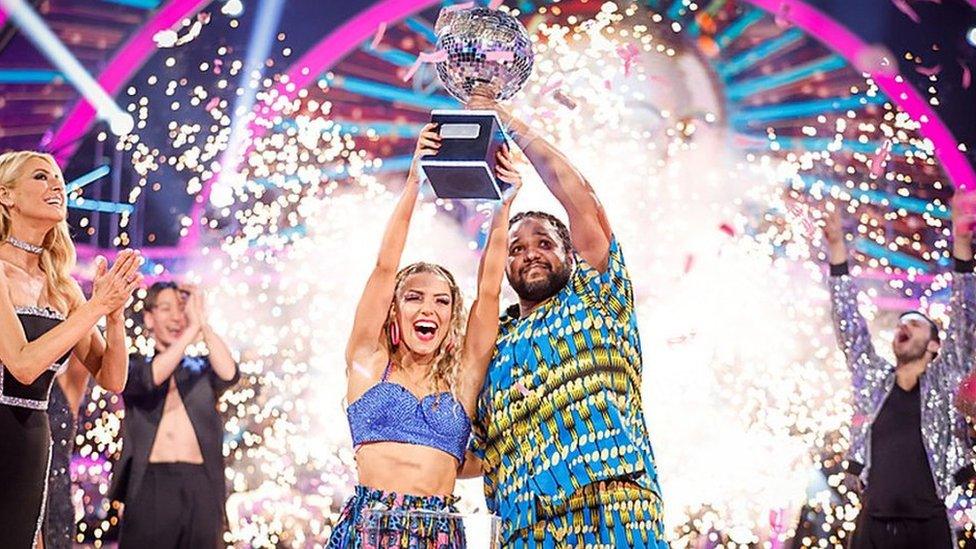 Hamza and Jowita lifting the glitterball trophy