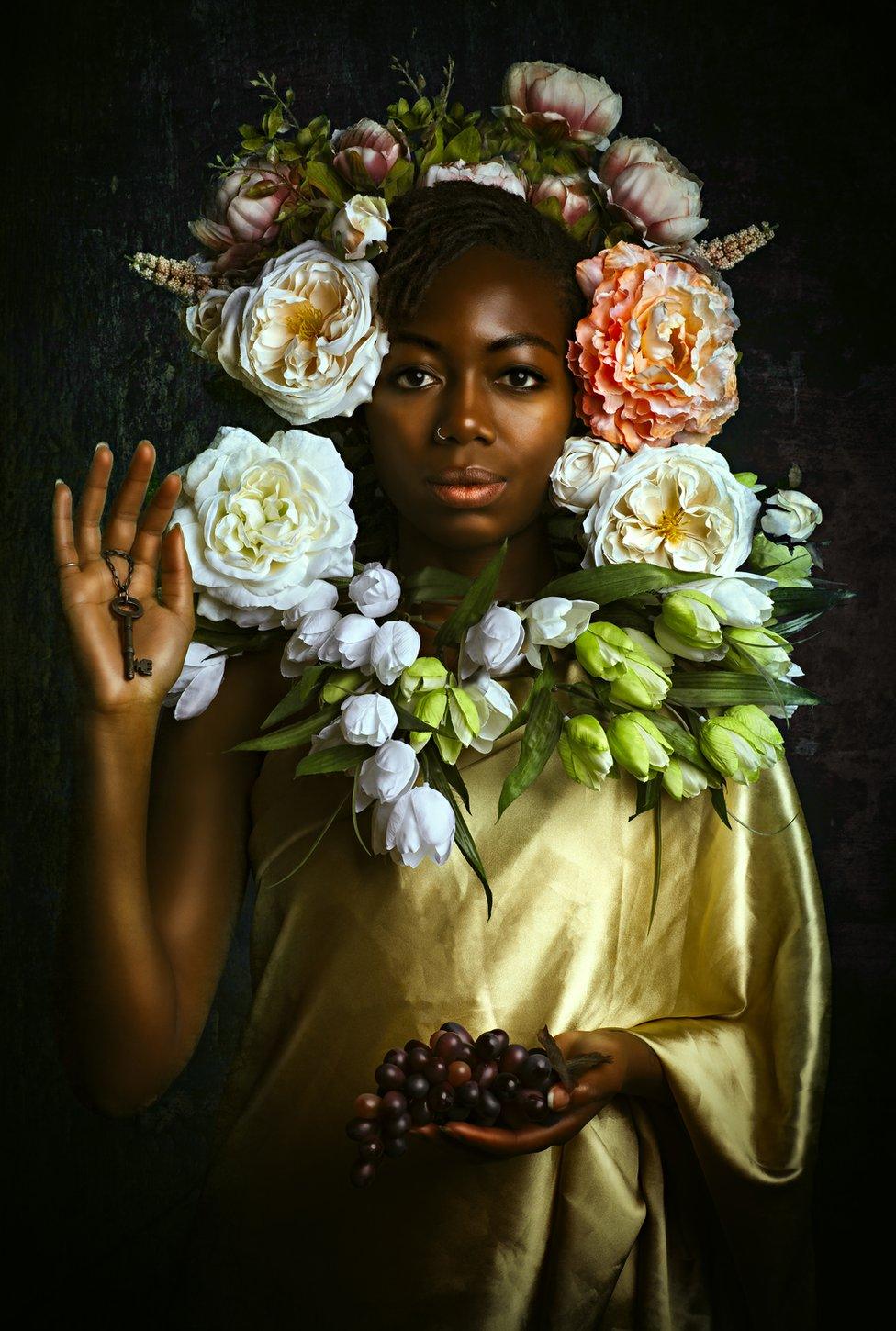 Portrait by Alanna Airitam showing a woman with a floral headdress