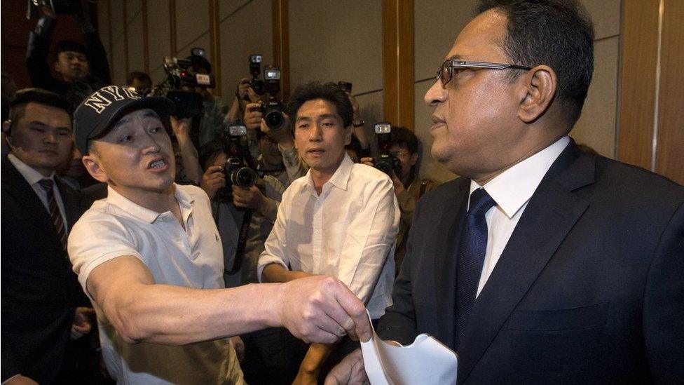 A relative of a victim complains to Ataur Safdar, head of British firm Reckitt Benckiser Korea, right, during a press conference in Seoul, South Korea, Monday, 2 May 2016