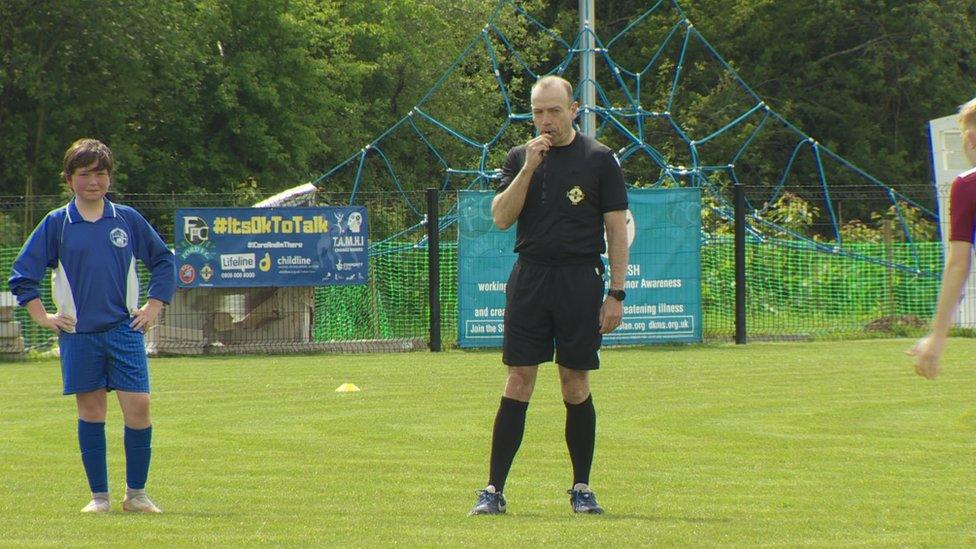 Christ Heaton-Harris refereeing a game of football in South Antrim