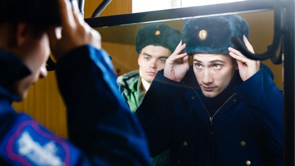 Russian conscript tries on uniform