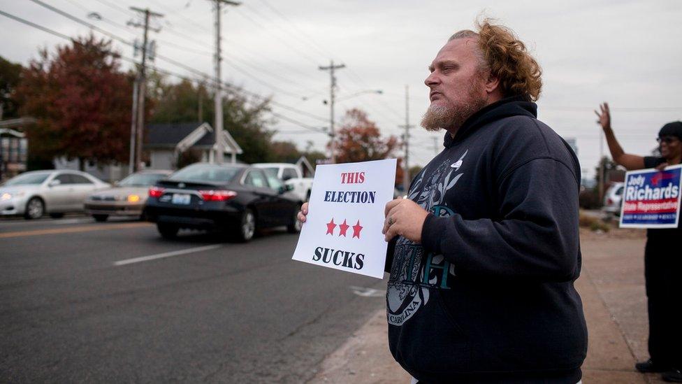 Douglas Hurt holds a sign in Bowling Green, Kentucky