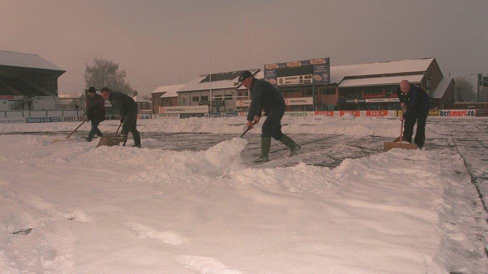 Ground staff clear the Welford Road snow