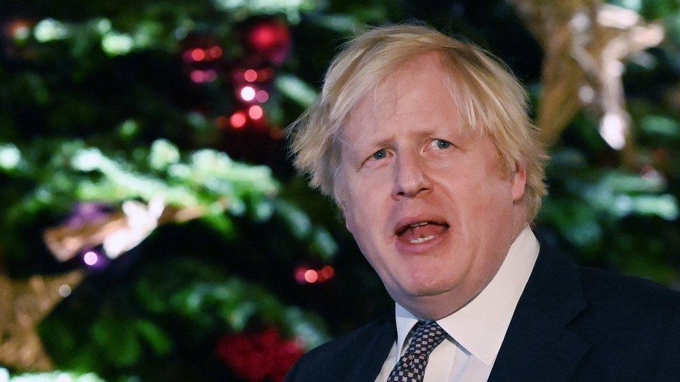 Boris Johnson delivers a speech at a Christmas market outside 10 Downing Street