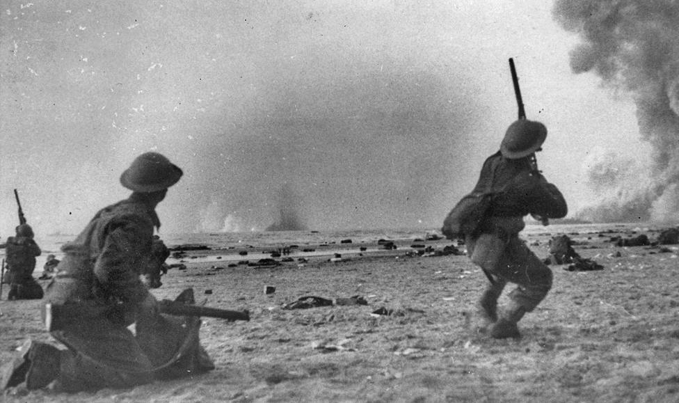 British soldiers shoot rifles at German aircraft attacking rescue ships at Dunkirk
