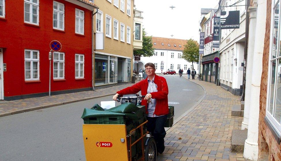 A Danish postal worker delivering in Copenhagen