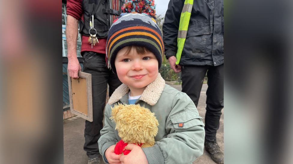 Toddler holding teddy bear