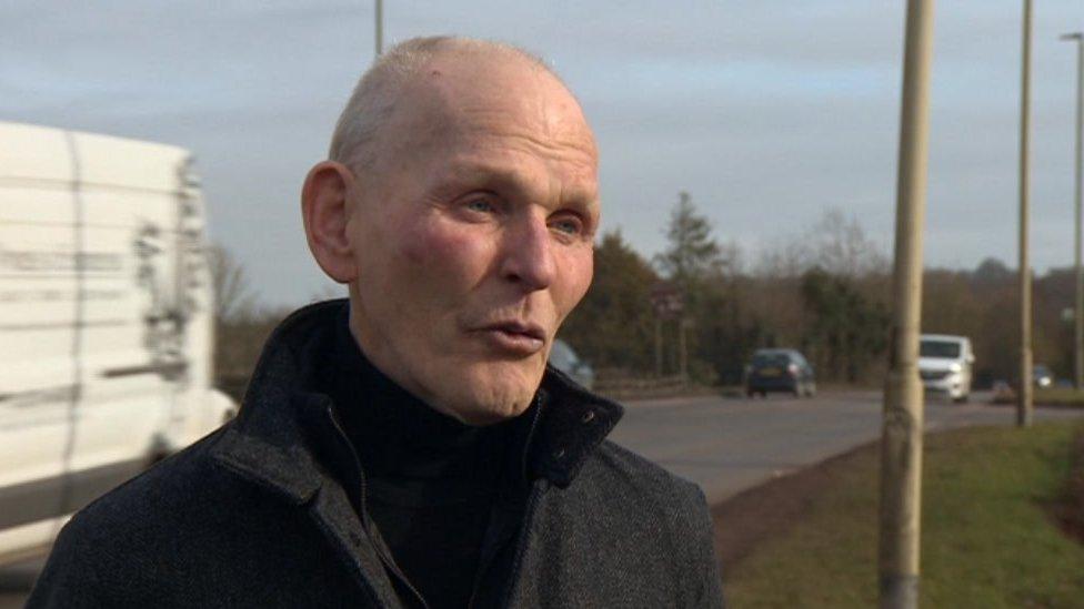 A man talking by the side of the A303