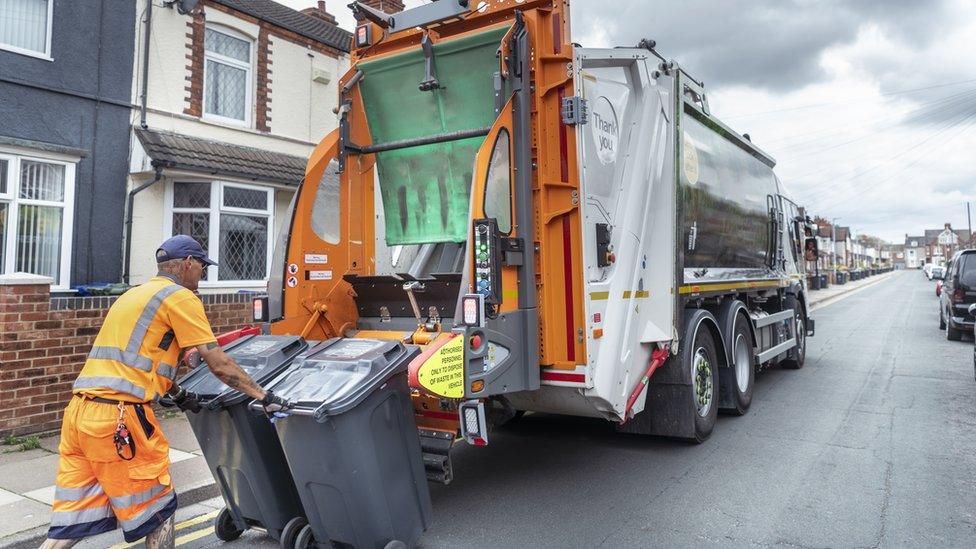 A worker collecting bin in Grimsby