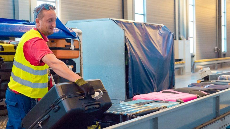 Stock image of man holding suitcase