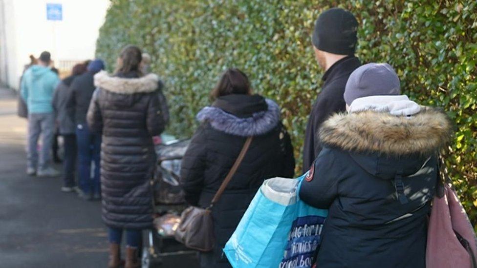 Families queue for food pantry