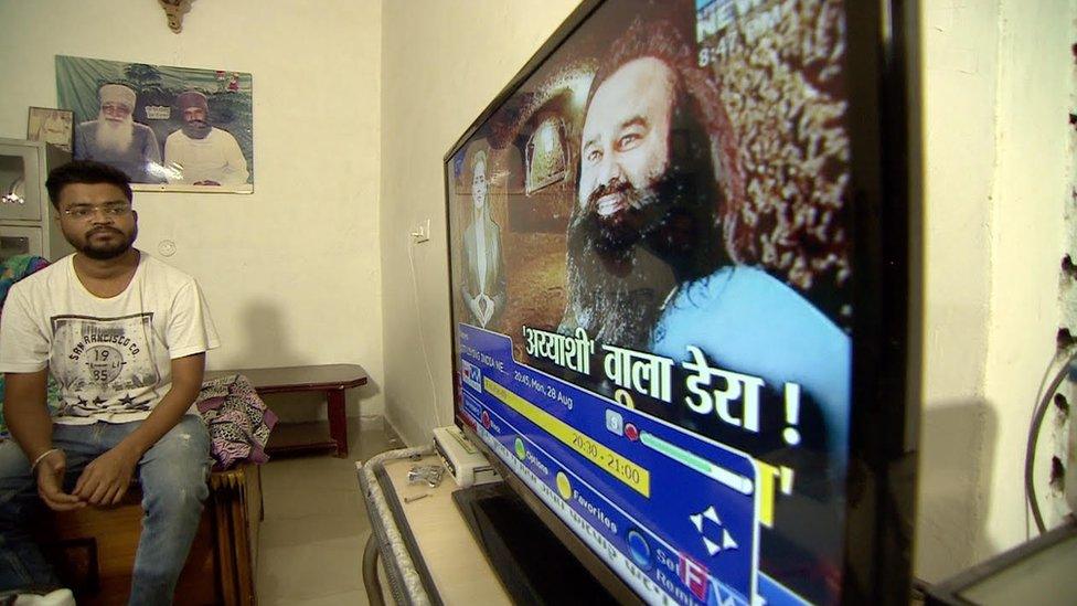 A man watches Singh on his television screen