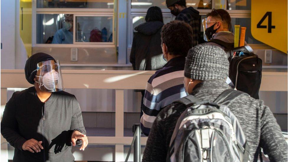 Staff at LAX airport move passengers through the line at the onsite Covid testing lab